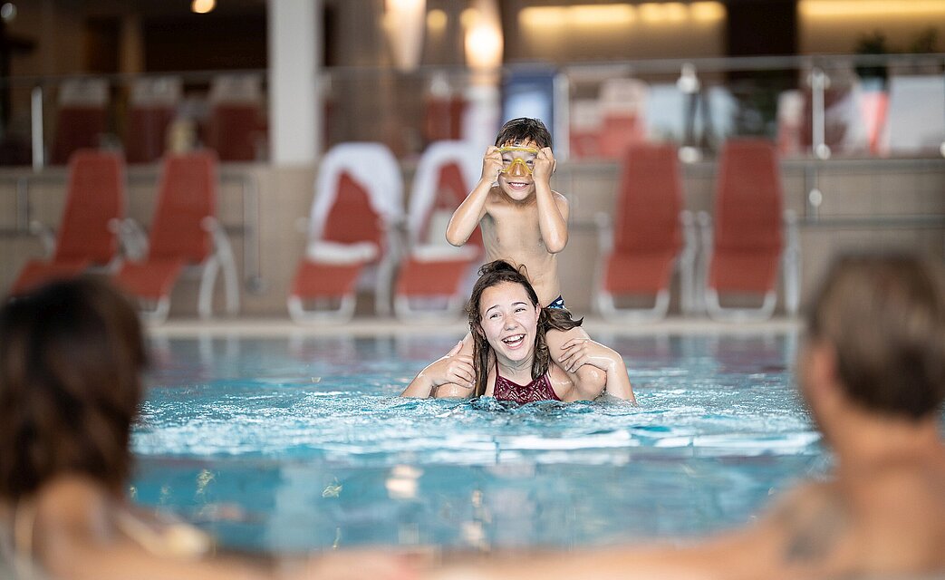 Family having fun at the indoor pool of the thermal spa resort Loipersdorf